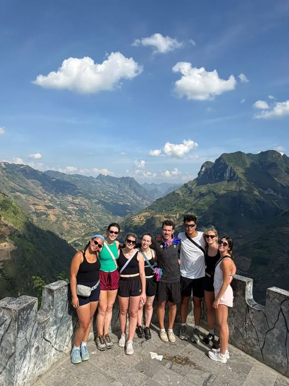 Small group of travellers at a Ha Giang Loop viewpoint with Nexus Hostel